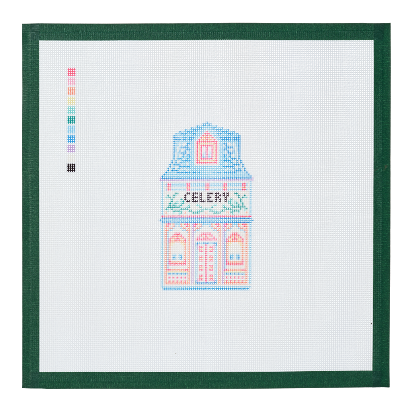 A needlepoint canvas of the Celery house, a small pastel building with its name on the front, on white mesh with a green taped edge.