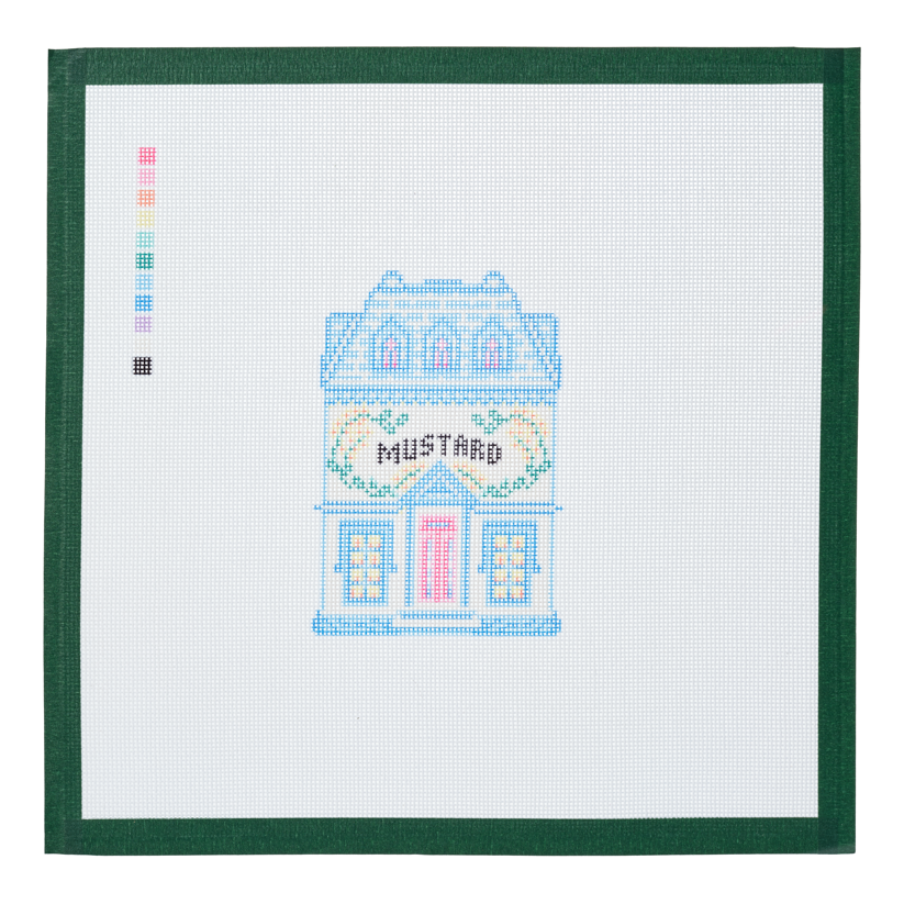 A needlepoint canvas of the Mustard house, a small pastel building with its name on the front, on white mesh with a green taped edge.