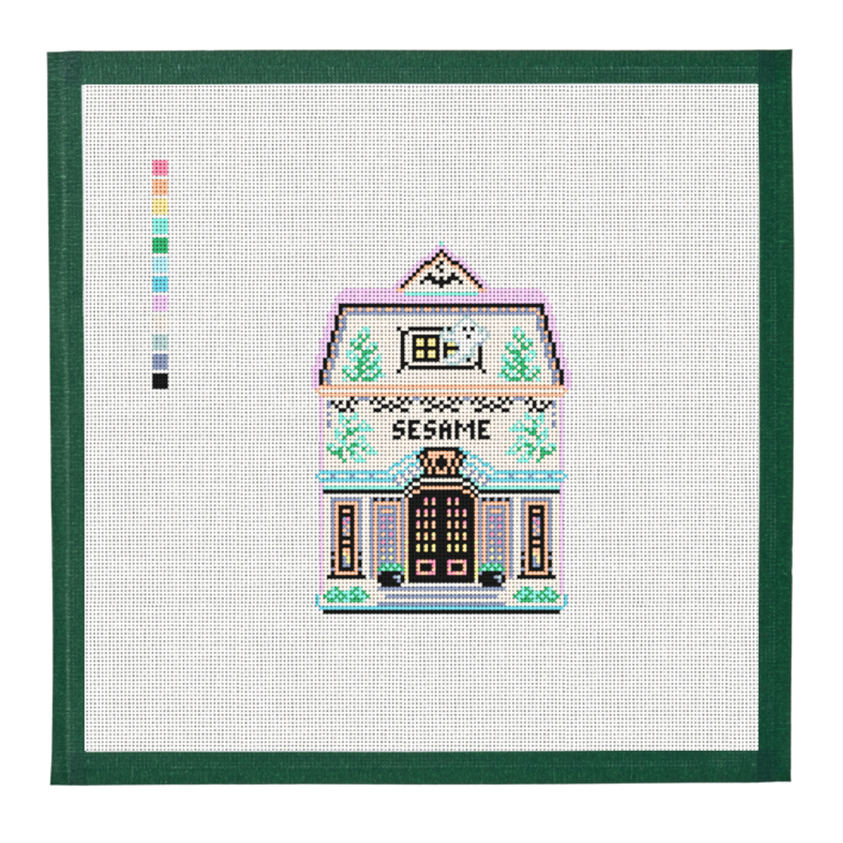 A needlepoint canvas of the Sesame house from the Halloween Spice Village, on white mesh with a green taped edge.