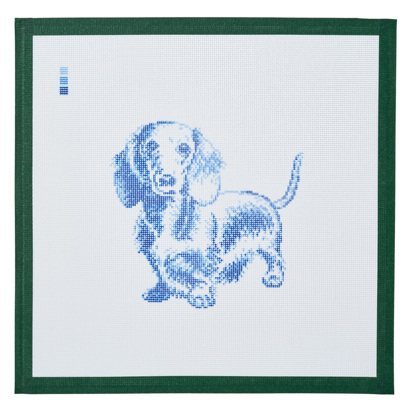 A needlepoint canvas printed with a long-haired dachshund in blue toile on white mesh.