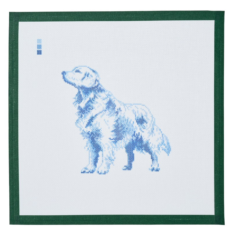 A needlepoint canvas printed with a golden retriever in blue toile on white mesh.