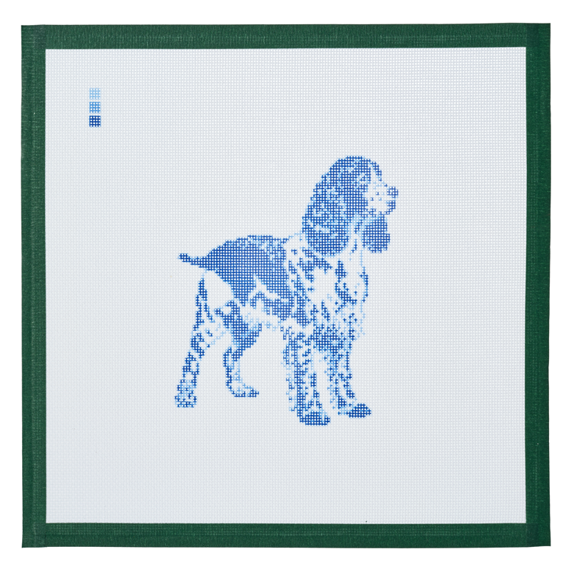 A needlepoint canvas printed with a springer spaniel in blue toile on white mesh.