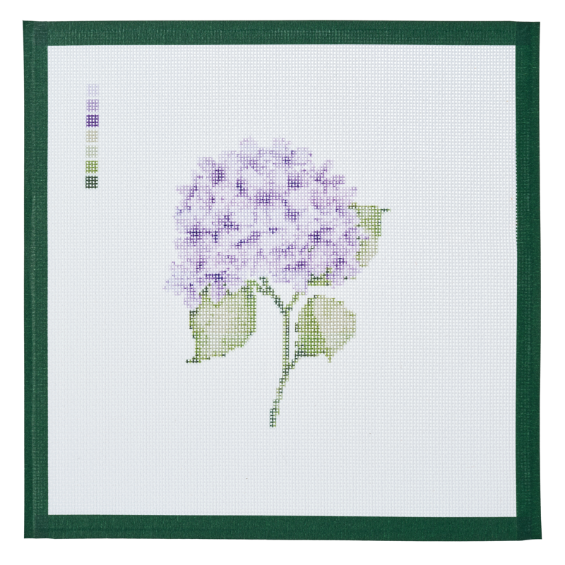 A needlepoint canvas printed with a purple hydrangea in bloom, on white mesh with a dark green taped edge.