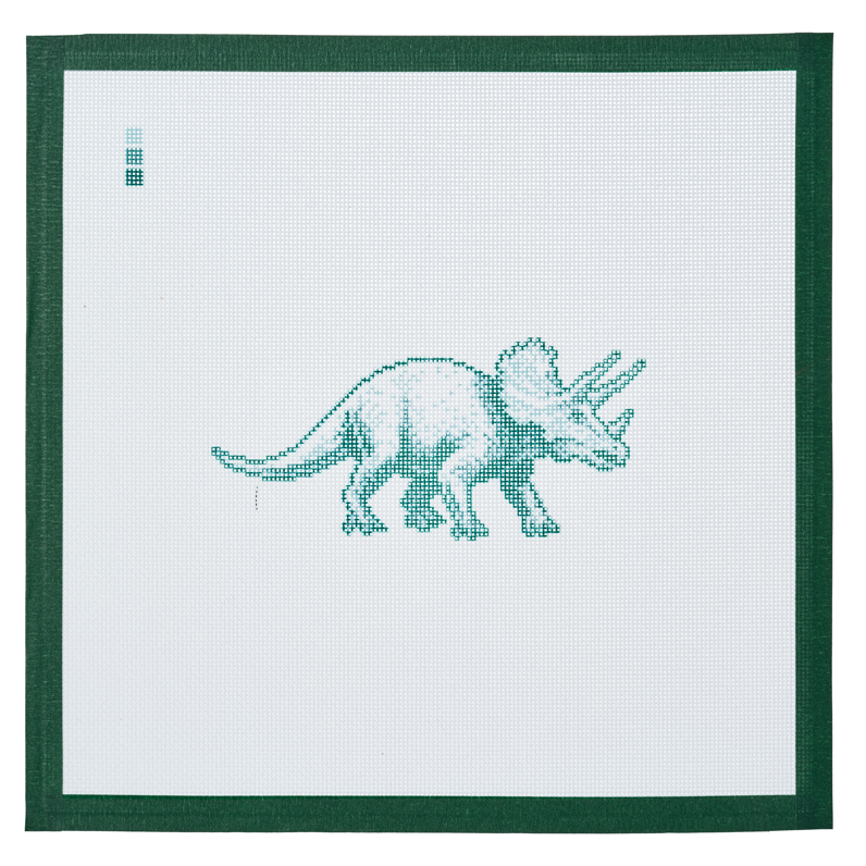 A needlepoint canvas printed with a triceratops, on white mesh with a dark green taped edge.