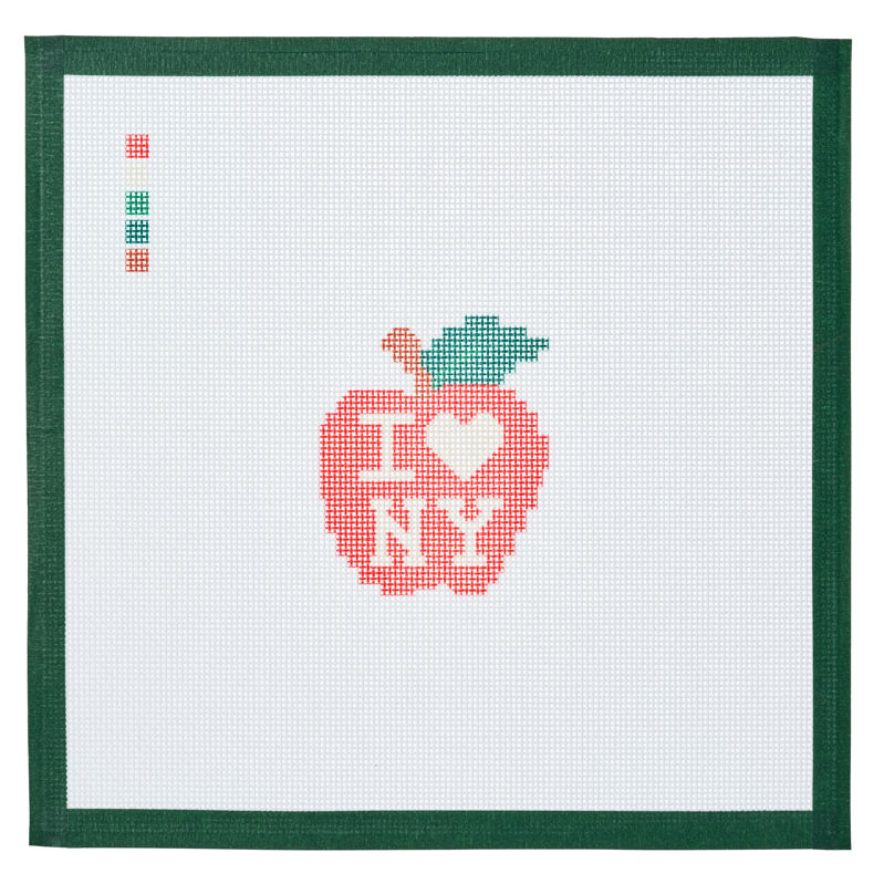 A needlepoint canvas printed with a heart and an apple, a small tribute to New York.
