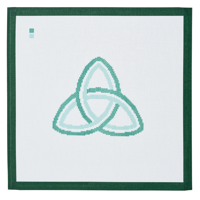 A needlepoint canvas printed with a green Celtic trinity knot on white mesh.