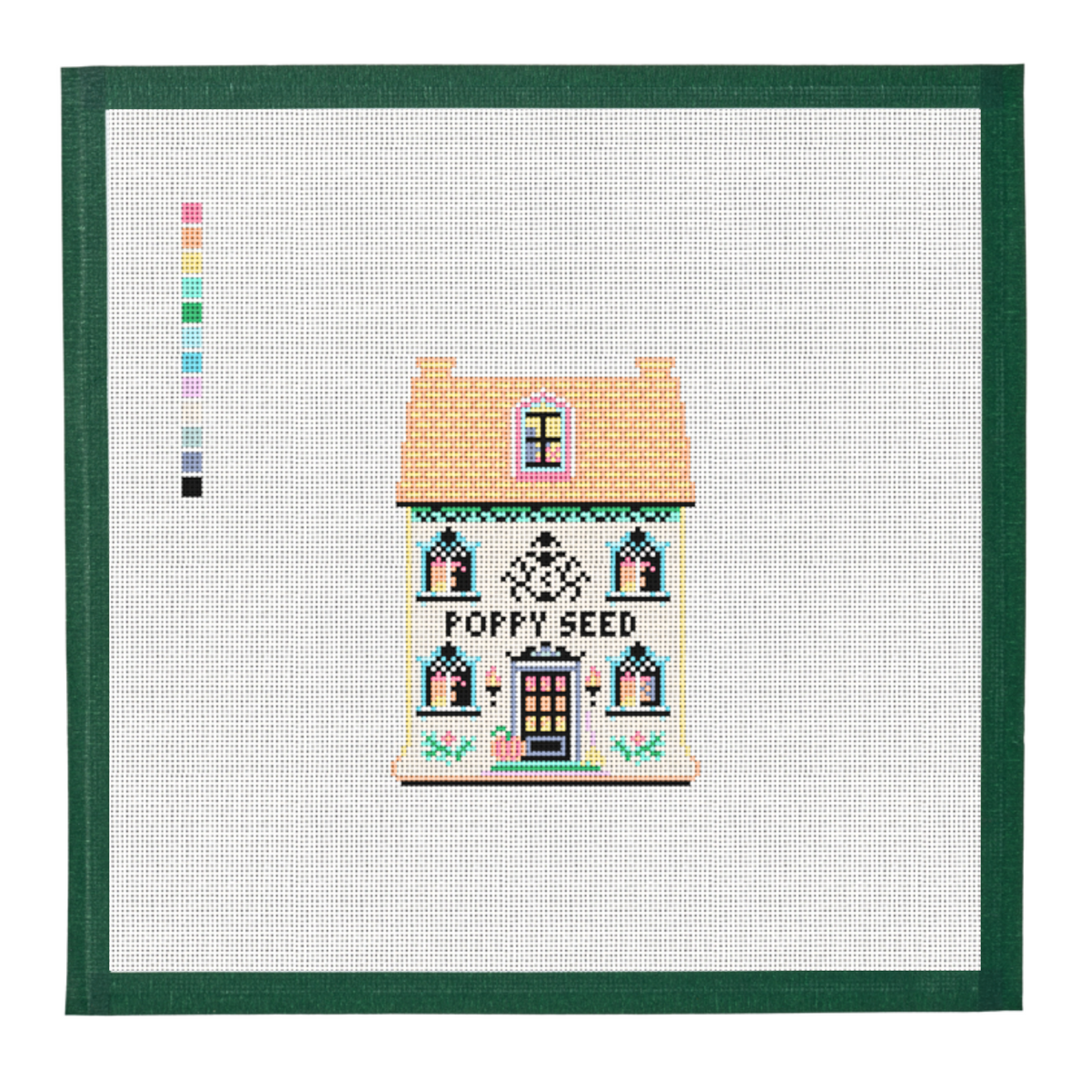 A needlepoint canvas of the Poppy Seed house from the Halloween Spice Village, on white mesh with a green taped edge.